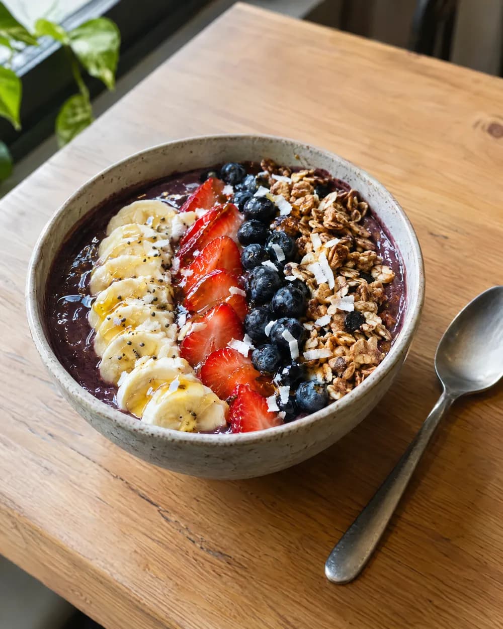 An açaí bowl topped with banana, berries and granola